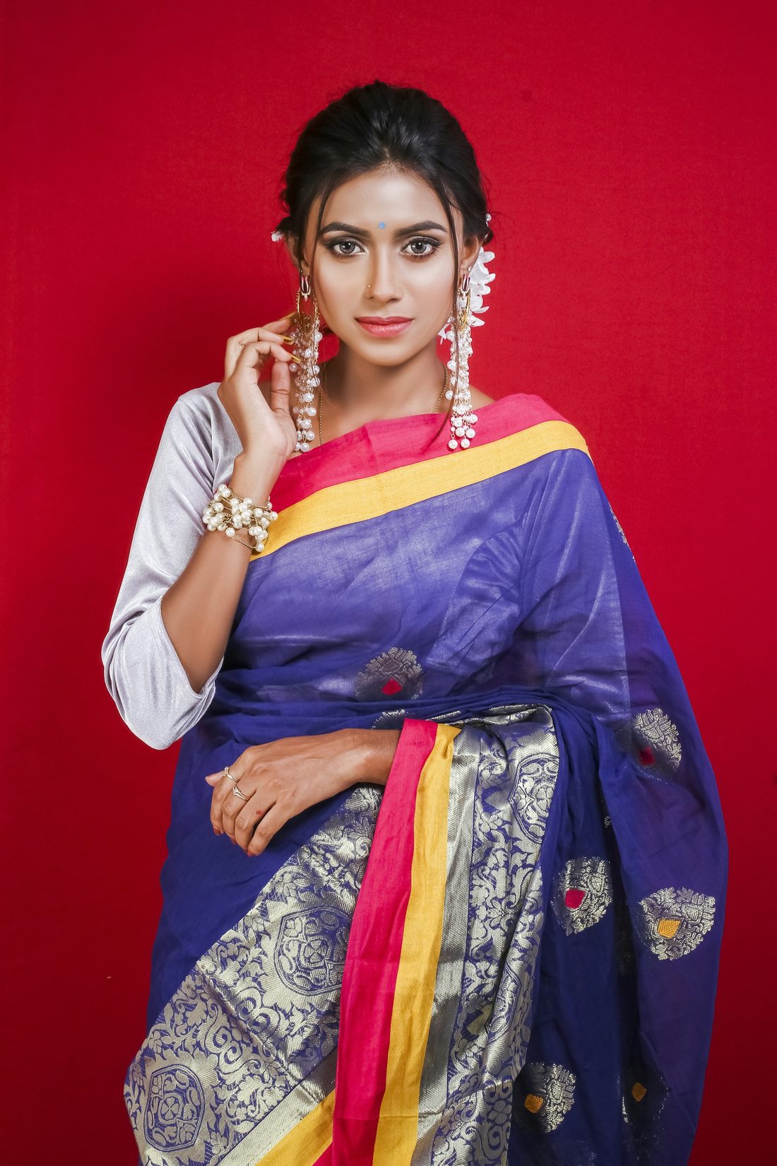 Royal blue cotton-silk saree with a yellow border and silver motifs